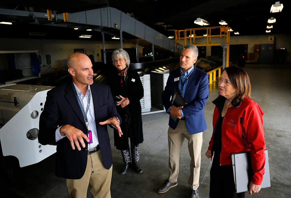 Buck Taft, Tri-Cities Airport director, guides Sen. Maria Cantwell on a tour of the airport terminal in Pasco. The visit followed an announcment of a $4 million federal grant as part of a 10-year renovation plan of the aiport. The grant money will be used to expand the outbound baggage area. Port of Pasco commissioner Vicki Gordon, back left, and Port of Pasco executive director Randy Hayden, back right, also take part in the tour.