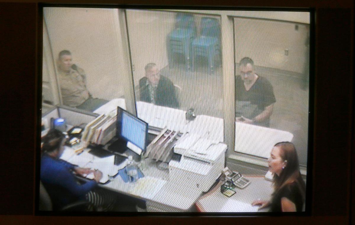 Accused child pornography distributor Daniel Bunch, 39, sits with attorney Eric Scott on Friday via a video link at the Benton County Justice Center in Kennewick. Deputy Prosecutor Laurel Holland, lower right, asks District Court Judge Steve Osborne to set bail at $200,000. Watch a video at: tricityherald.com/video