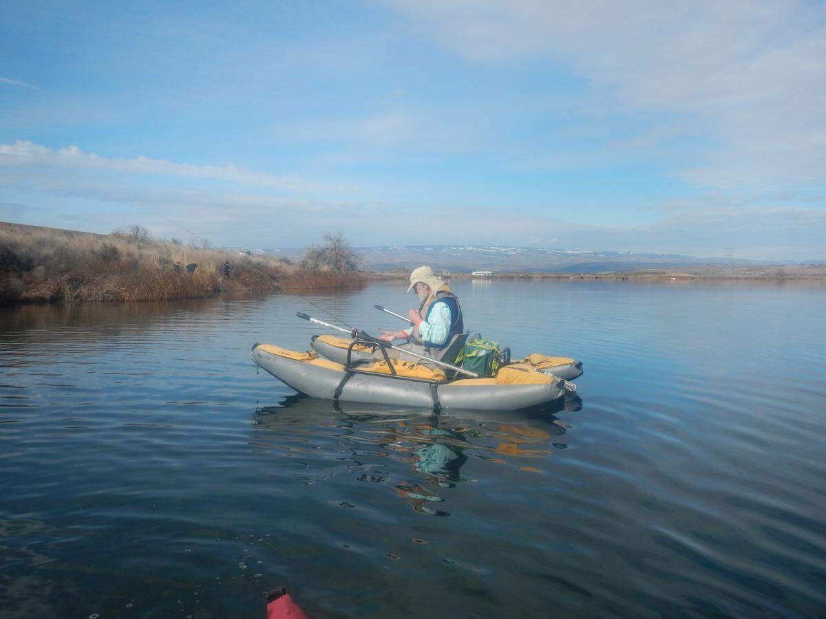 Ted Poston organizes his gear before venturing out for a day of trolling flies on Quincy Lake.