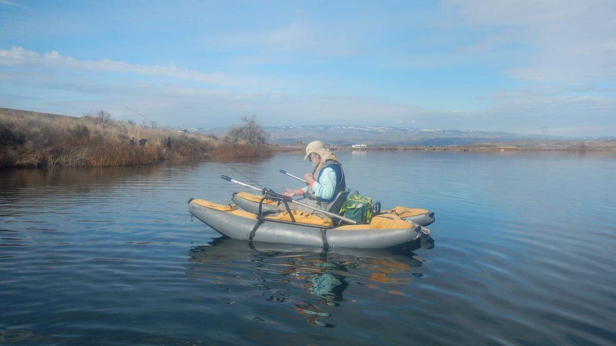 Ted Poston organizes his gear before venturing out for a day of trolling flies on Quincy Lake.