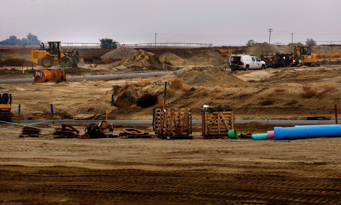 Earth moving equipment and construction workers prepare the ground for a new residential subdivision off Burns Road west of Broadmoor Boulevard in west Pasco.