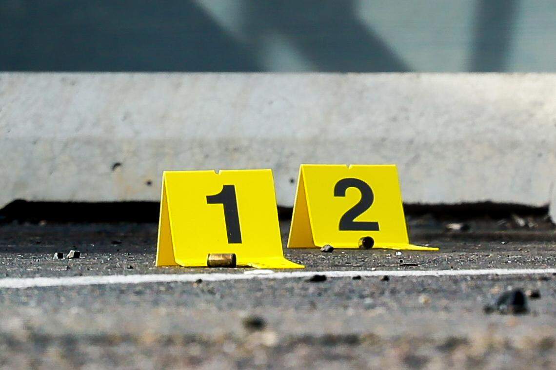 Evidence is marked on the steps of the Heatherstone Apartments on Sunday afternoon.