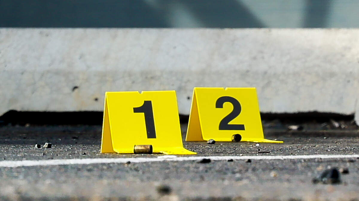 Evidence is marked on the steps of the Heatherstone Apartments on Sunday afternoon.