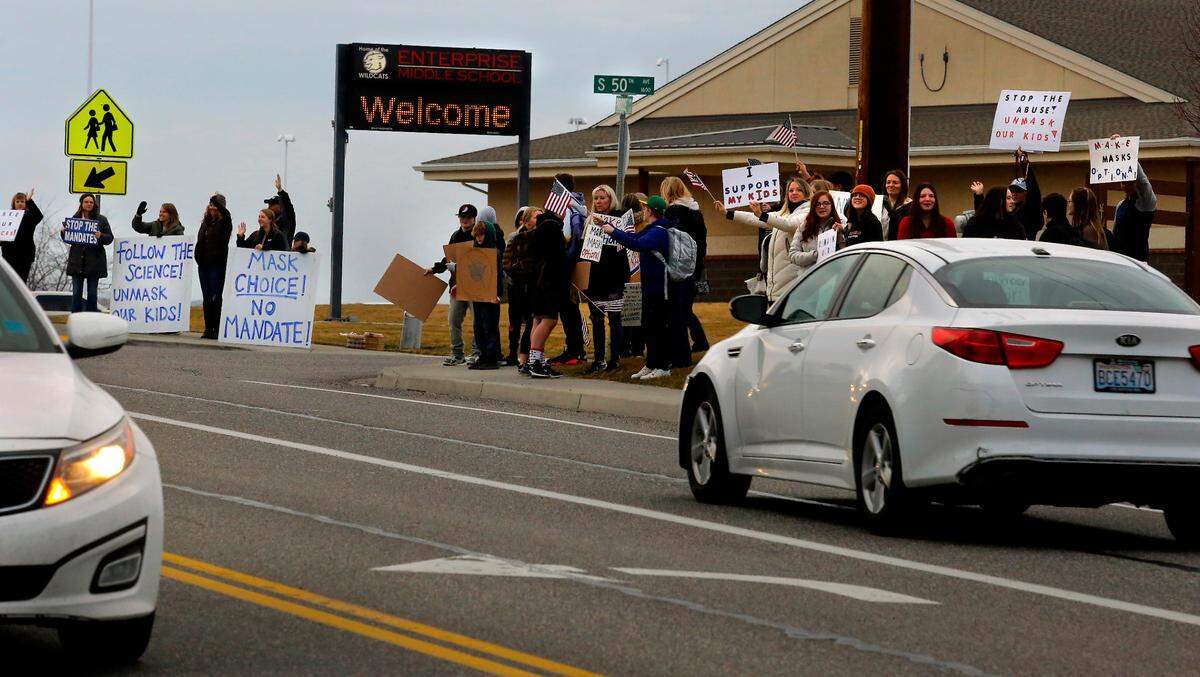 Several dozen Enterprise Middle School students, parents and supporters for mask choice stand in front of the West Richland school.
