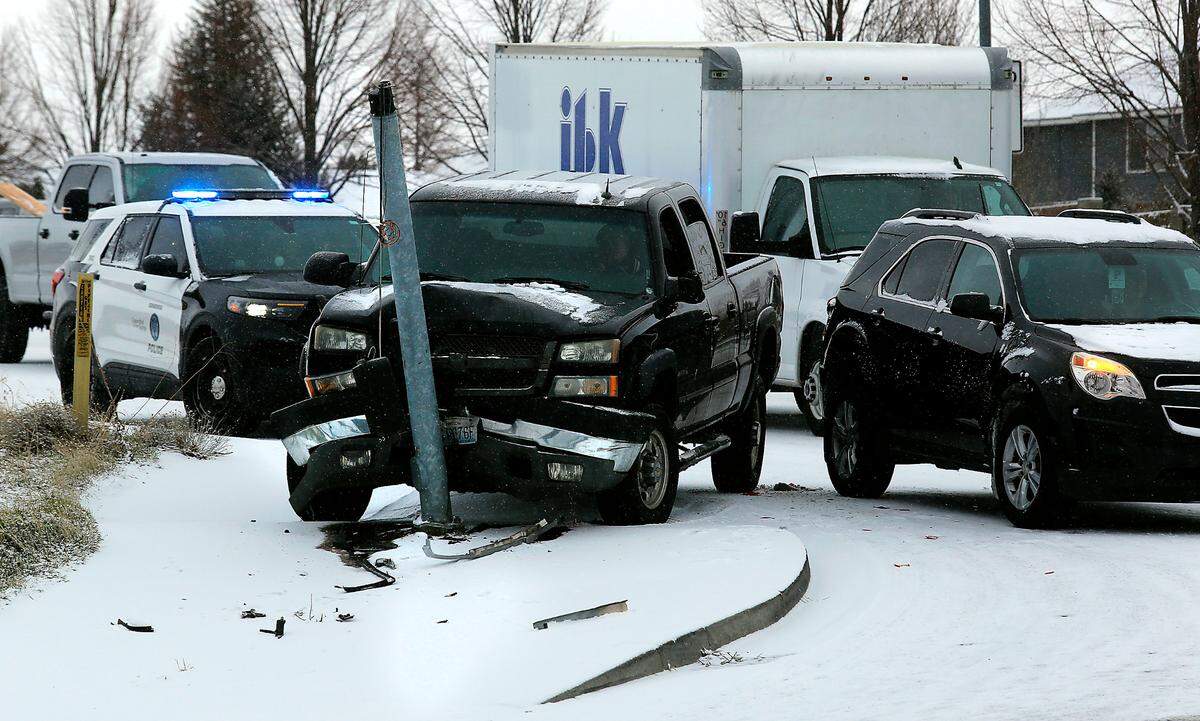 A Kennewick police cruiser blocks traffic at the intersection of West Clearwater Avenue and North Steptoe Street following a two-vehicle collision involving a crosswalk signal pole early Thursday.
