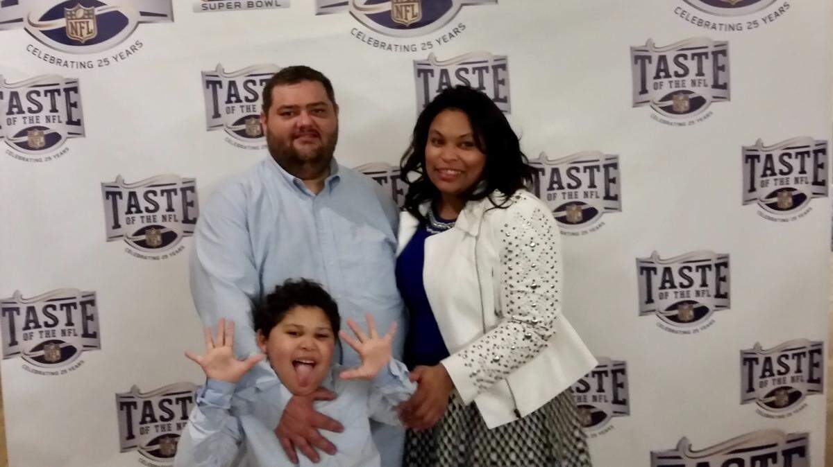 Dallas Chef Israel Vorin and wife Brandy enjoy a playful moment with son Sebastian at the Taste of the NFL celebrity event.