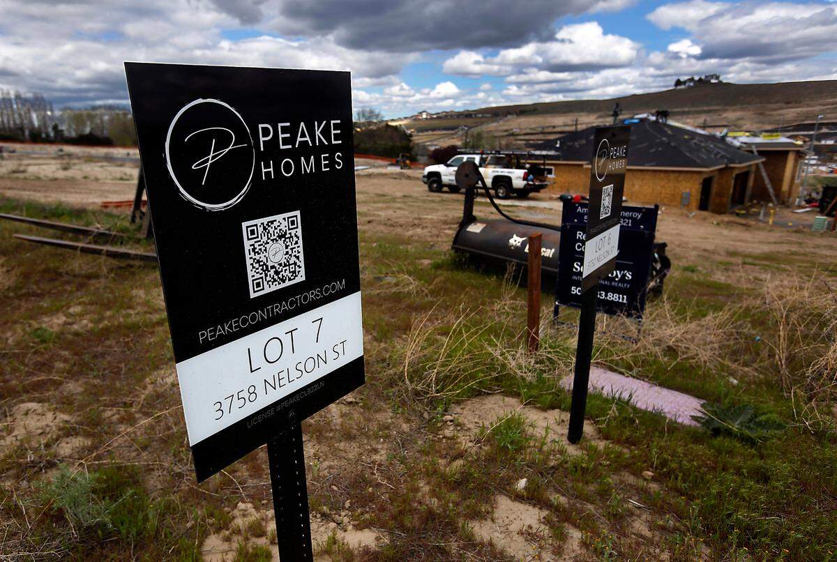 Signs stuck in the ground designate individual lots at the Sage Crest housing development by Peake Homes on South Nelson Street just off Ridgeline Drive in south Kennewick.