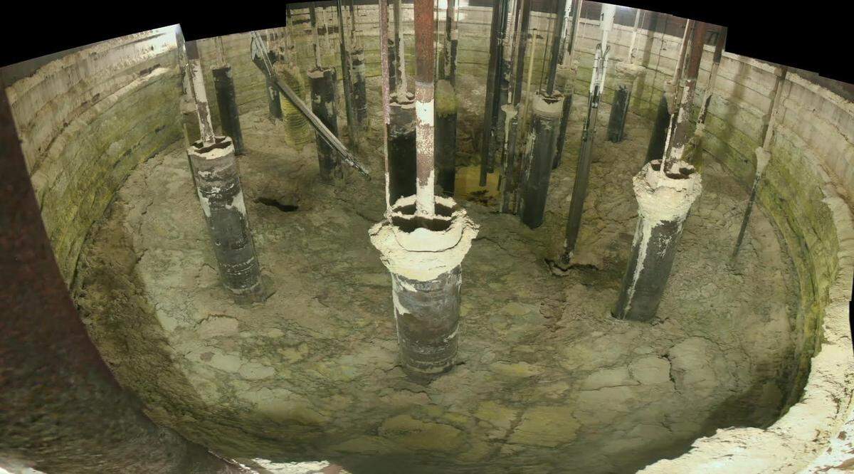 A photo from inside AX-101 before waste retrieval started in January 2023 shows radioactive and chemical waste in the tank and collected on walls and other in-tank equipment.