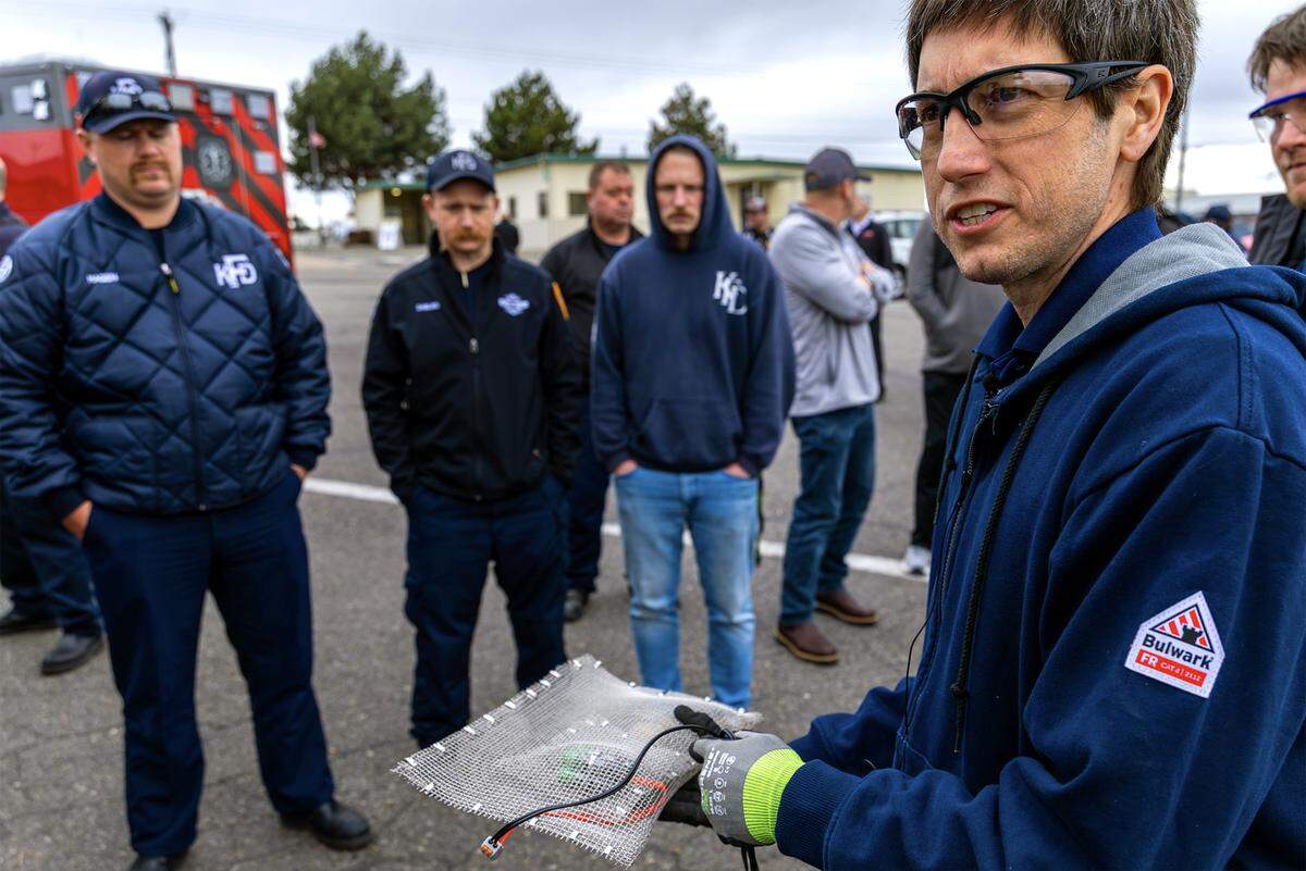 Stephen Ball,with the Environmental Protection Agency educates regional firefighters about lithium-ion battery fire during a live fire training demonstration Thursday afternoon in Kennewick.