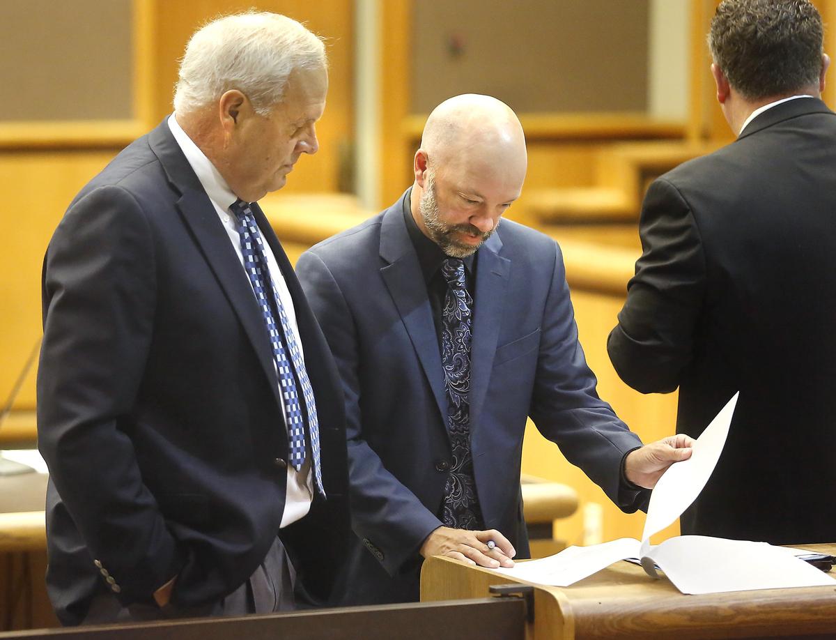 Benton Prosecutor Andy Miller, left, and defense attorney Ryan Swinburnson look through court paperwork before the start of Thursday’s hearing in Kennewick for WinCo shooting suspect Matthew McQuin. Watch a video at: tricityherald.com/video