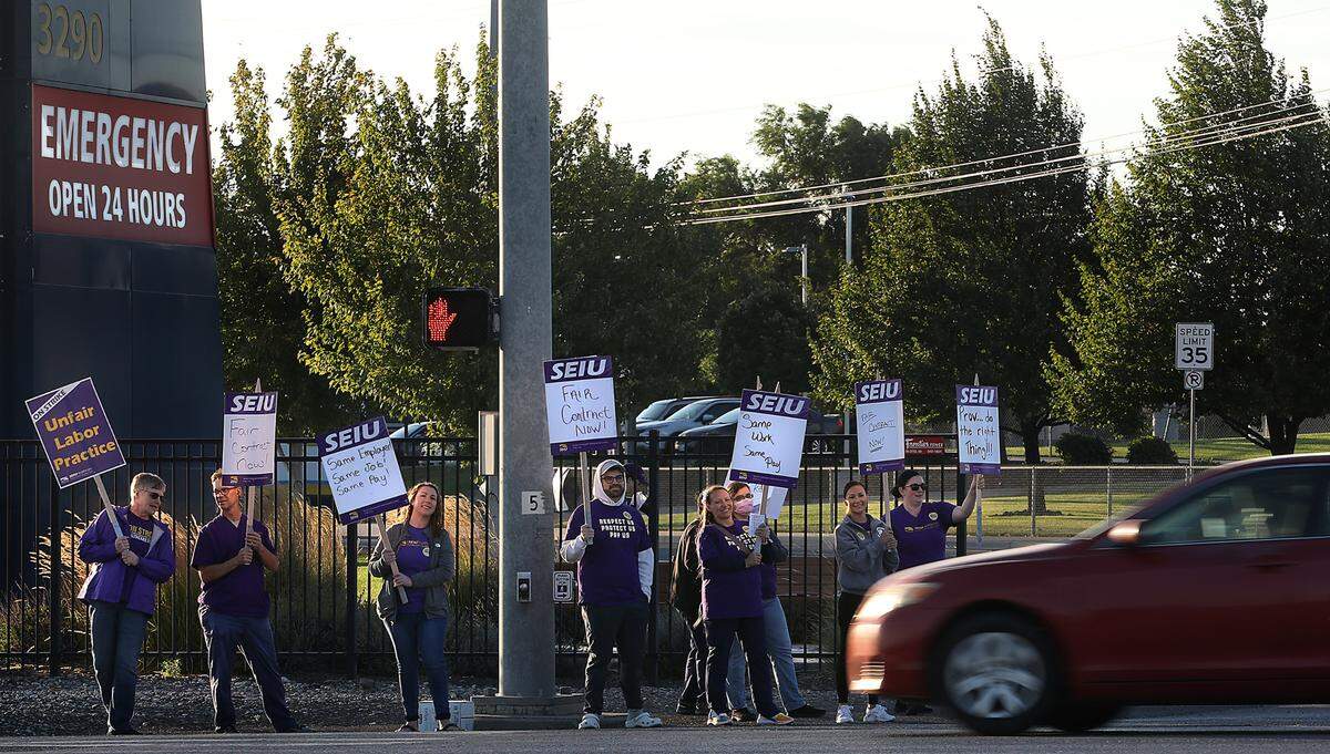 Technology and service employees employed by Kadlec Regional Medical Center waved signs outside the freestanding emergency room off Highway 395 in Kennewick on the first day of a weeklong strike in August.