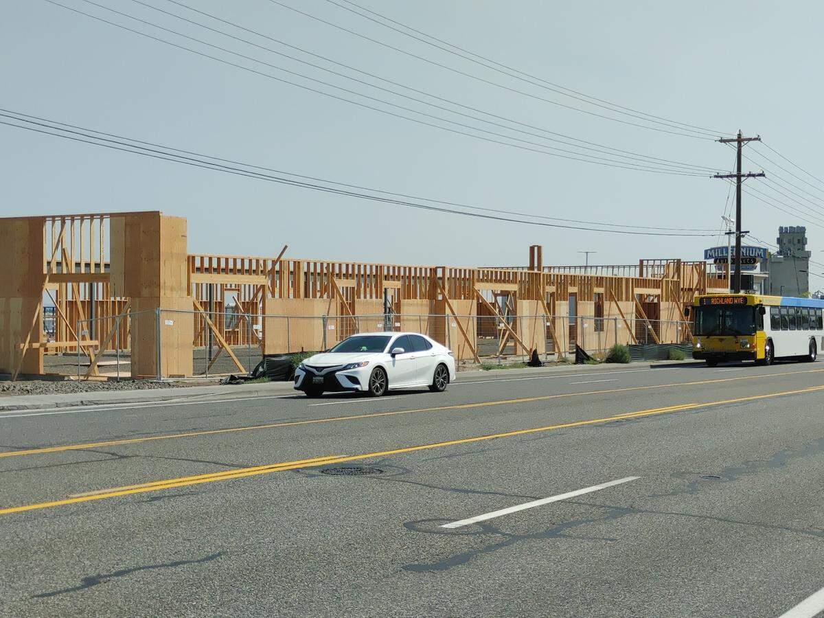 Mendoza Investments LLC of Kennewick is building a professional office building on a site next to its existing business, Millennium Auto Sales.