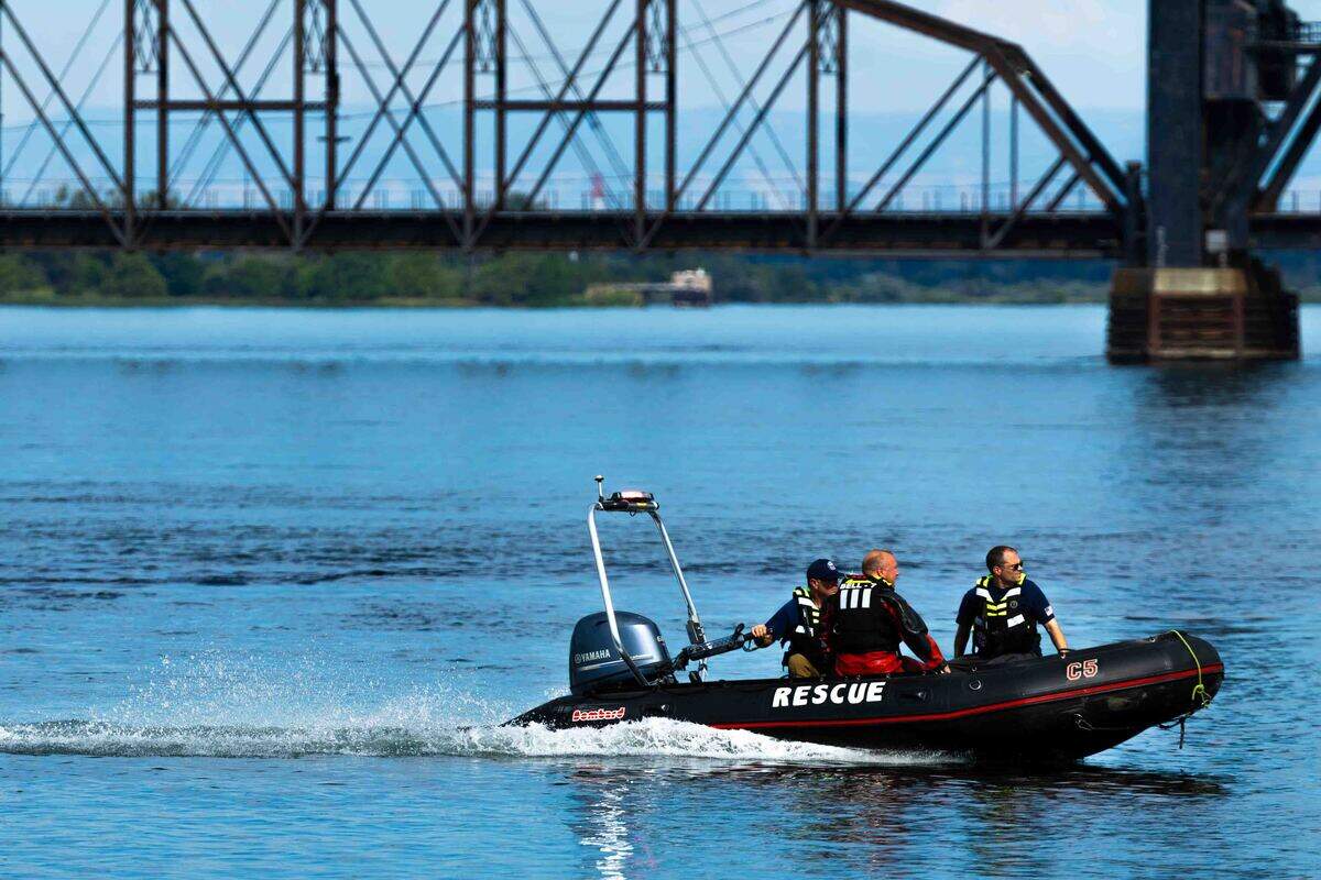 Rescue boat members were on hand Wednesday to help with the recovery of the plane after the crash in the Columbia River near Pasco.