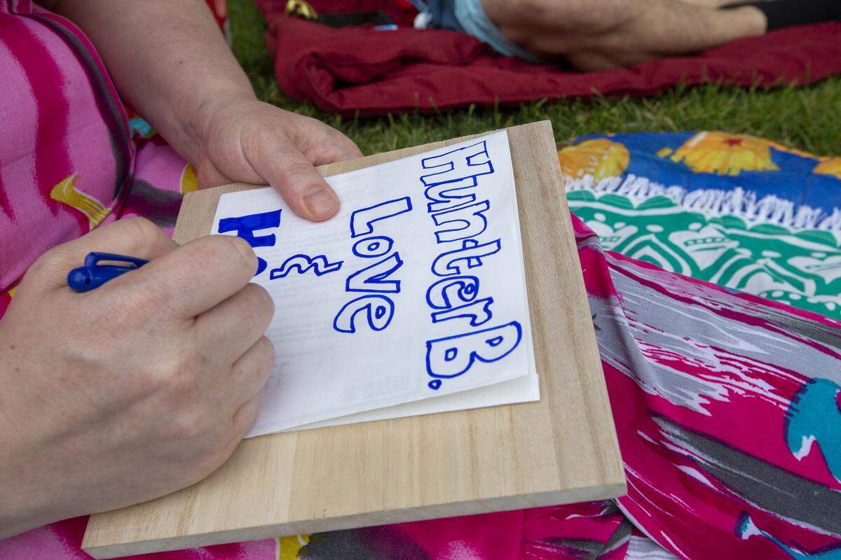 Dalyn Larsen, Hunter Black’s sister, writes a message to her brother on a lantern during the Water Lantern Festival. Family and friends planned to memorialize him during the event releasing water lanterns into the pond.