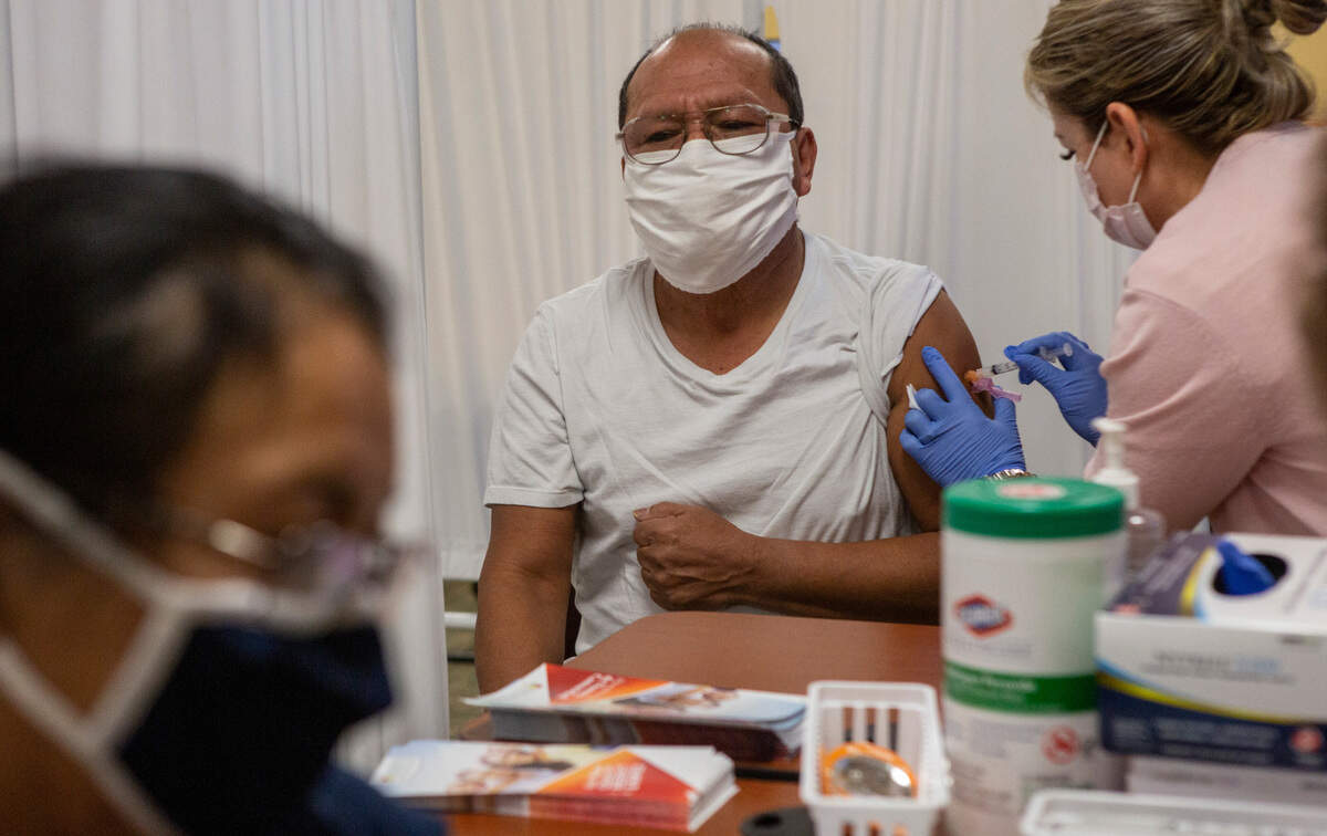 Efigenia, 57, and Juanito Marcial, 66, of Benton City, were the first in line at the COVID-19 vaccination clinic at Tri-Cities Community Health in Pasco on Friday. The couple got in line at 1 a.m.