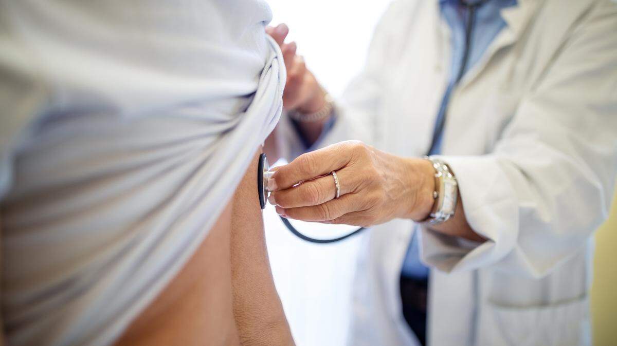 Cropped of doctor examining patient. 