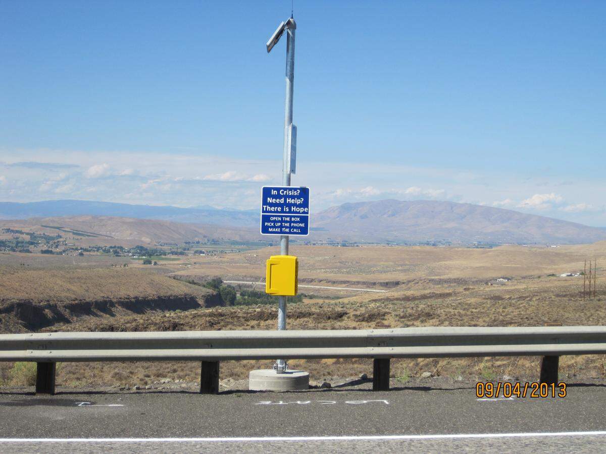 The instructions on call boxes installed near the Fred G. Redmon Memorial Bridge are simplified for people who are in crisis and may be contemplating suicide. Open the box, pick up the phone and make the call for help and hope.