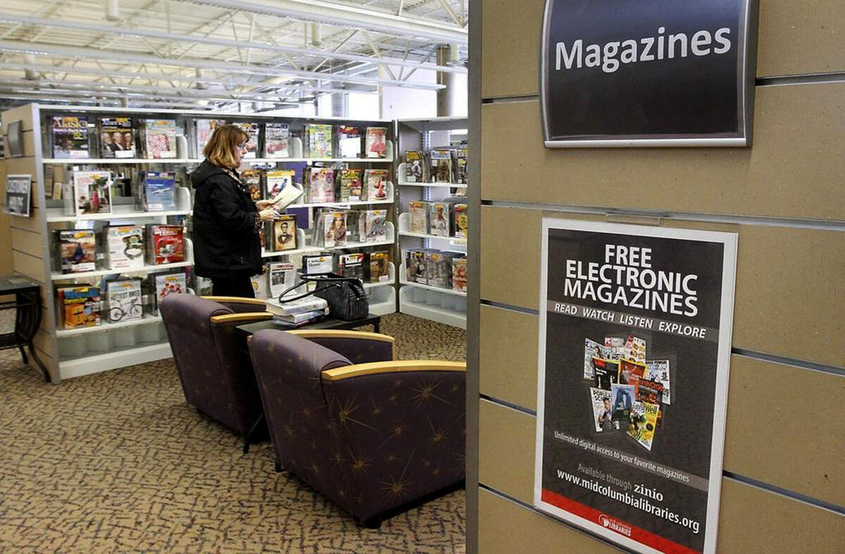 A library patron visits the Kennewick branch of the Mid-Columbia Libraries on South Union Street.