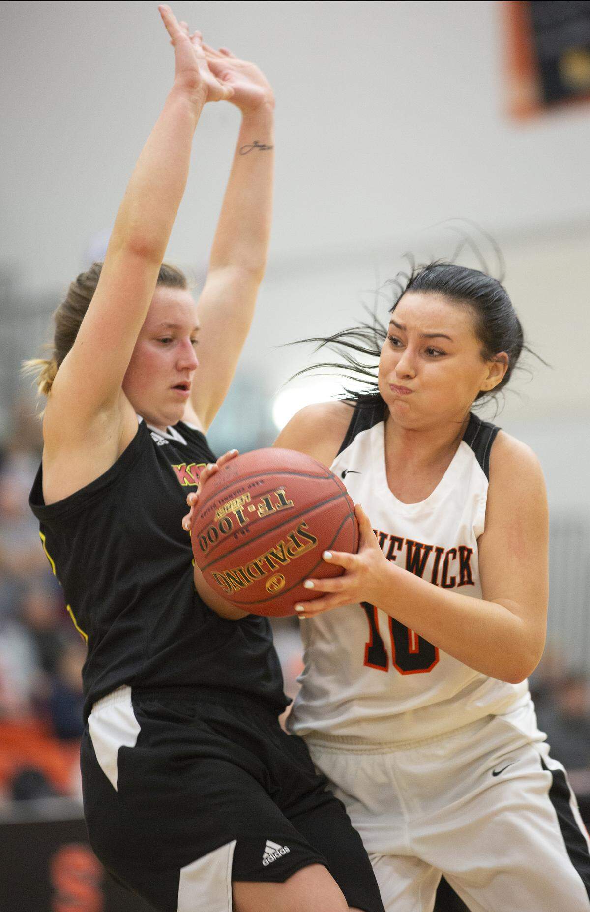 Kamiakin’s Alexa Hazel (22) defends as Kennewick’s Aislin Fiander (10) tries to make a pass during a recent game at Kennewick.