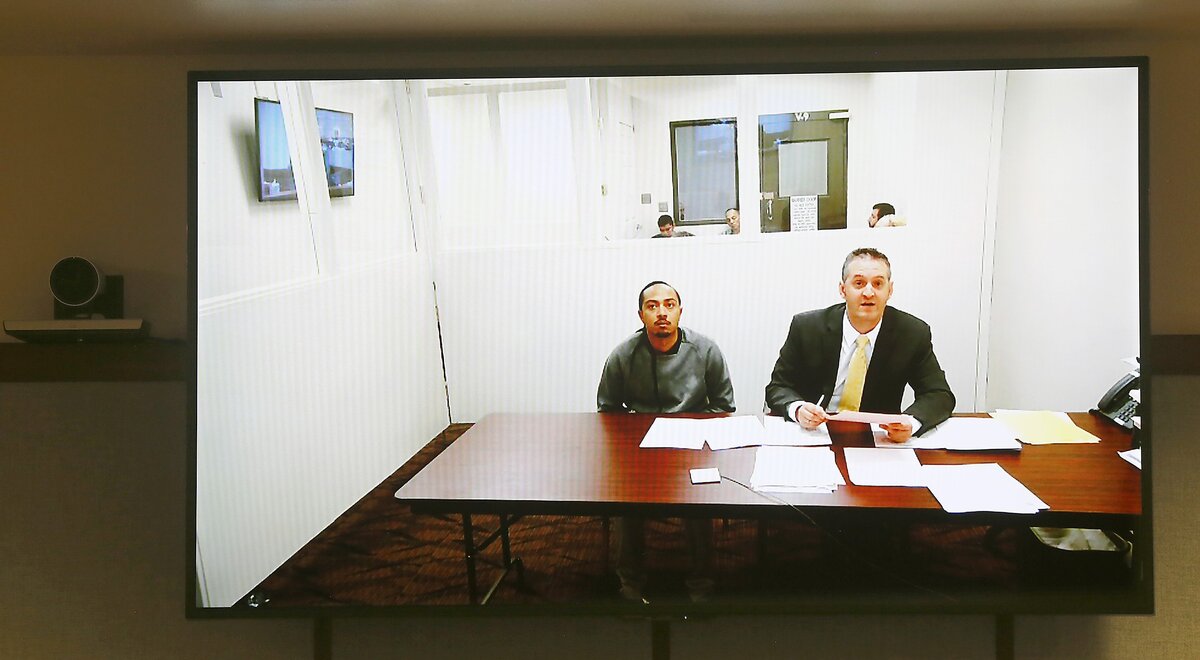 Edward L. Nelson, 28, appears Monday via a video link in Franklin County Superior Court with attorney Michael Quillen, right.