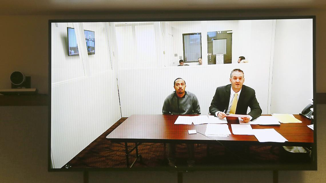 Edward L. Nelson, 28, appears Monday via a video link in Franklin County Superior Court with attorney Michael Quillen, right.