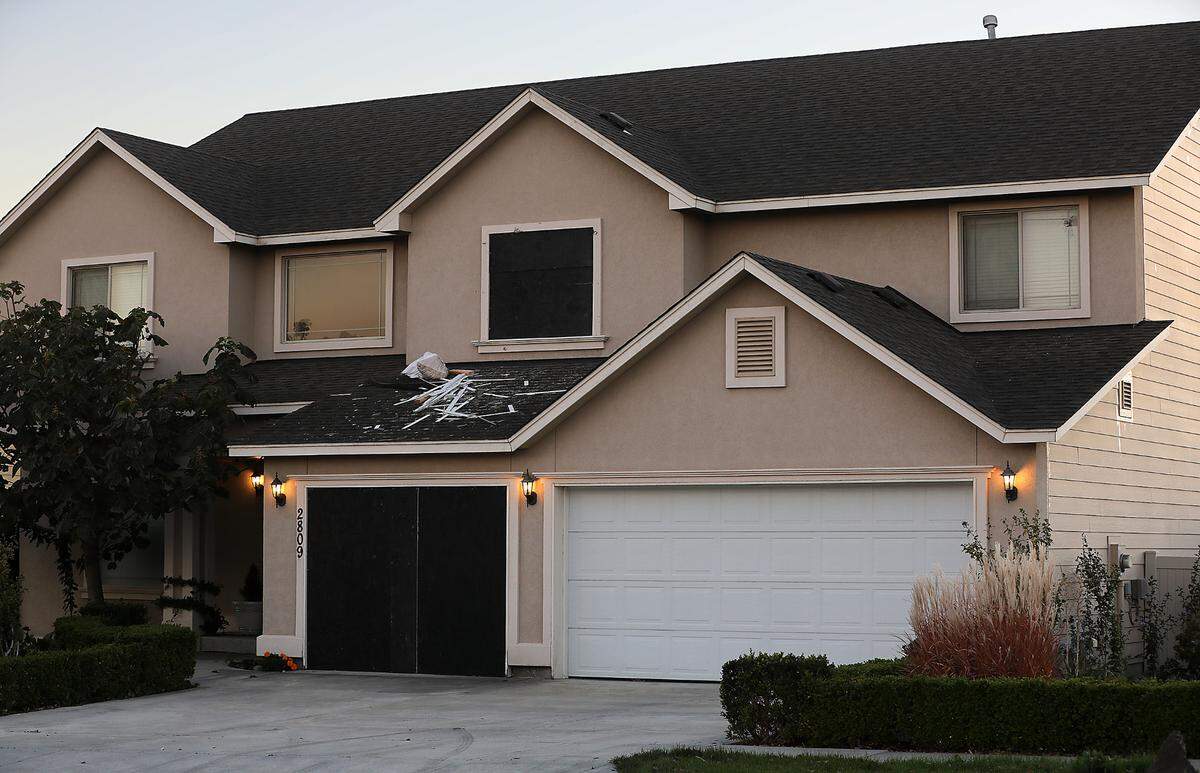 The Kennewick home on South Dawes Street has a couple doors and window boarded over after Kennewick police discovered three bodies inside after receiving reports about a missing couple who lived there. Nabil Mohamed, 65, Hifza Khan, 63, and Zuhaid Mohamed, 26, were found dead inside on Tuesday Oct. 17, according to a news release from the Kennewick Police Department. Police say they are investigating if this is a double homicide and a suicide but they said it was too early in the investigation to draw a conclusion.