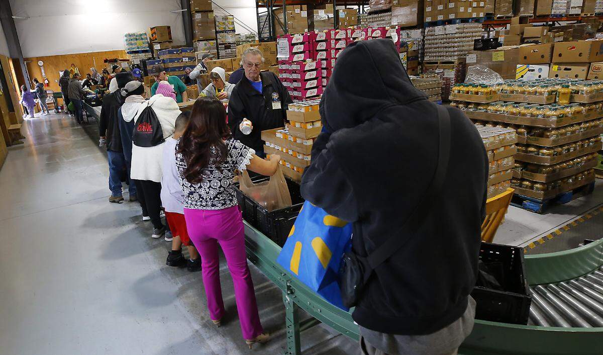 Recipients work their way through the line during a recent food distribution day at the St. Vincent de Paul Food Bank & Community Services campus in Pasco.