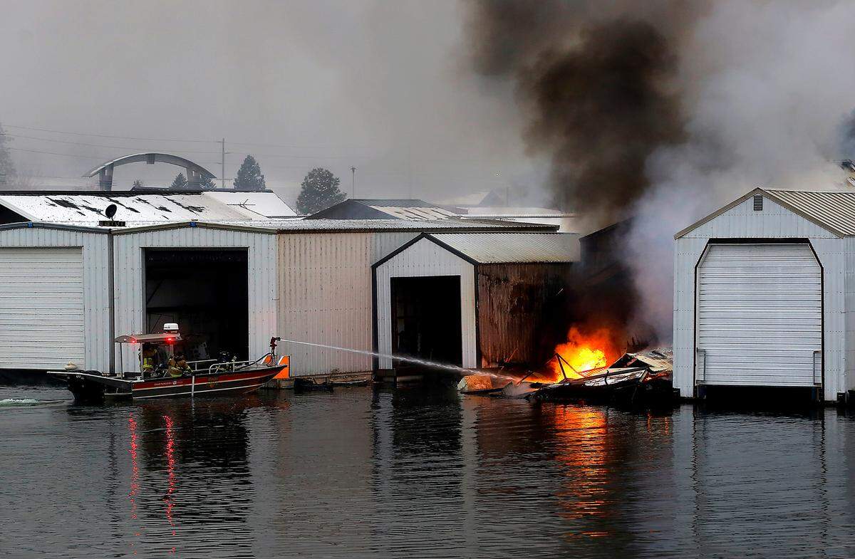 Firefighters in the Pasco Fire Department fire boat work to extinguish a boathouse fire in December at the Clover Island Yacht Club in downtown Kennewick.