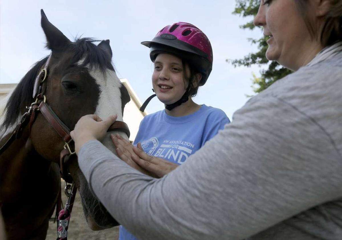 Sofia Martinez, 16, of Prosser, interacts with a TROT horse last year.