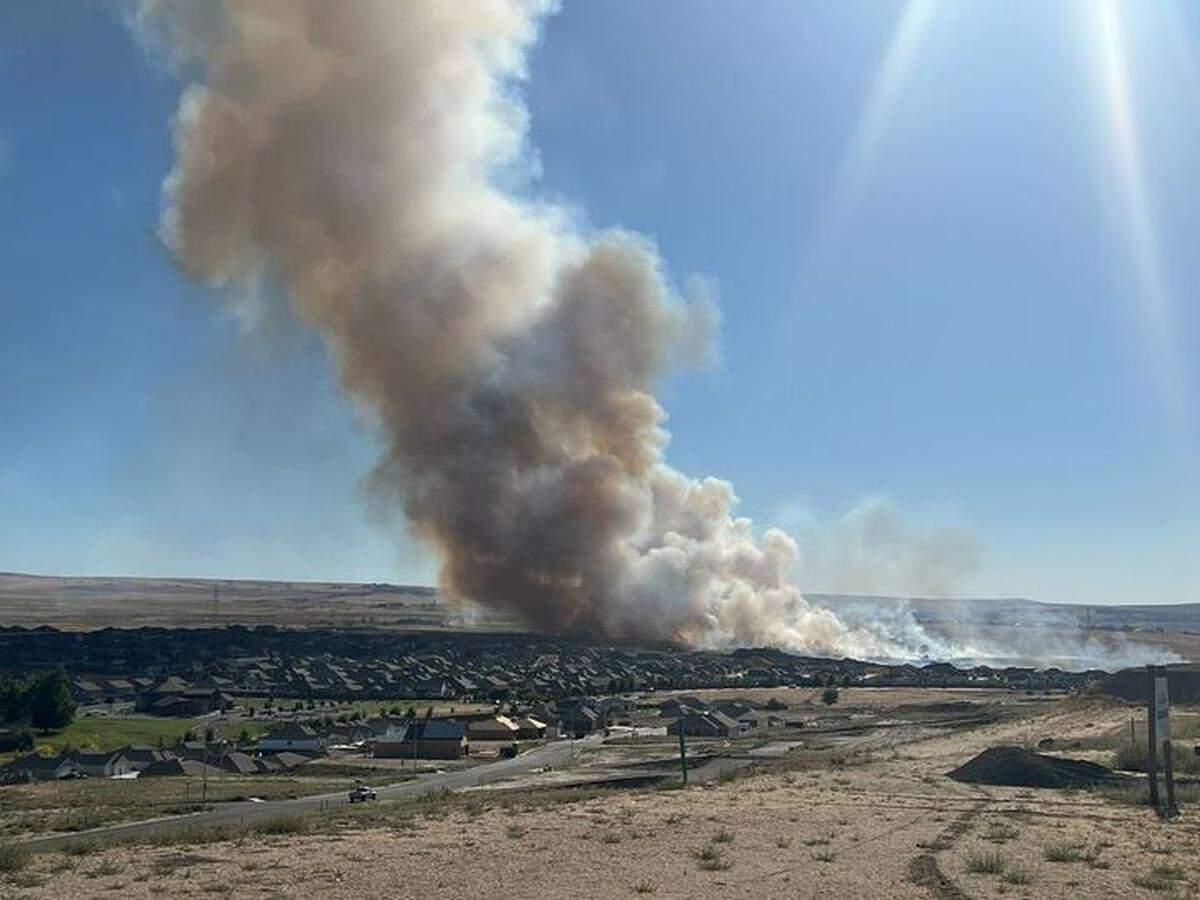A dramatic-looking plume of smoke drifts over south Kennewick from a grass fire Friday afternoon.