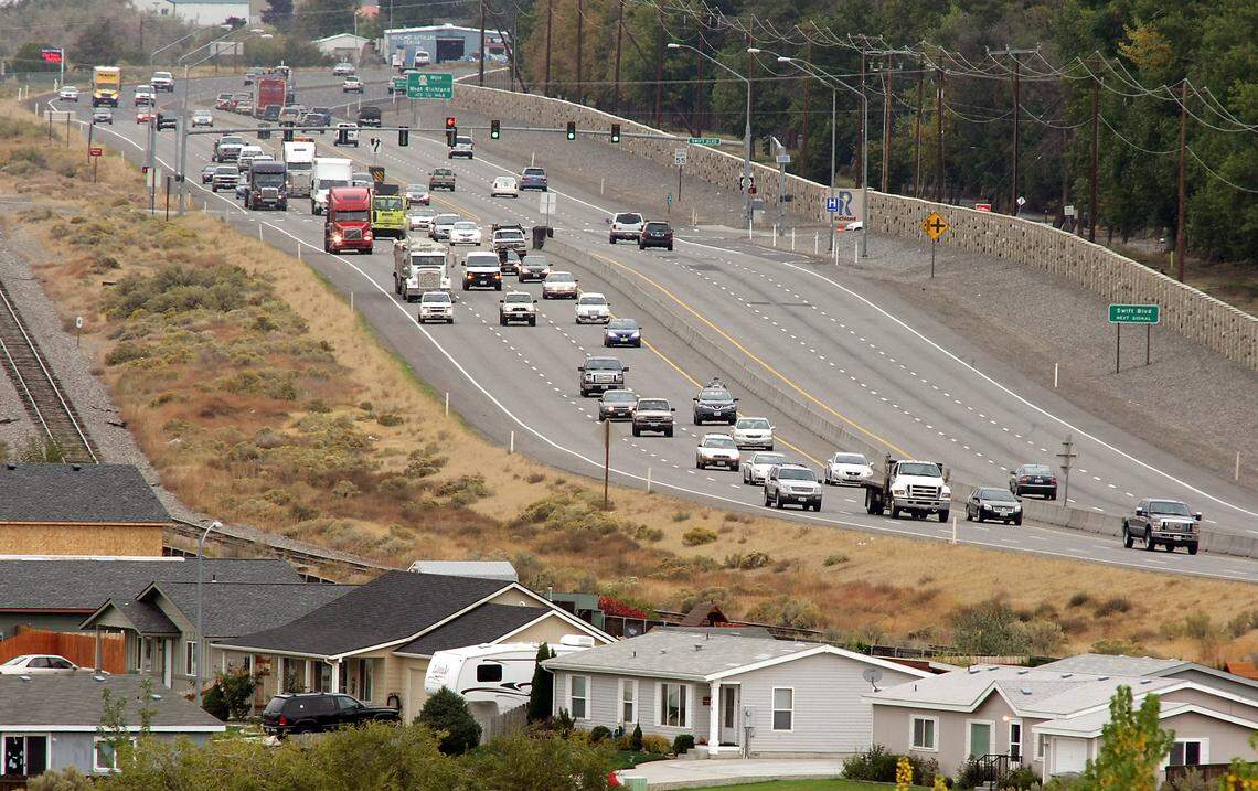 Afternoon traffic streams from Hanford on the bypass highway around the city of Richland., with light traffic the other direction.