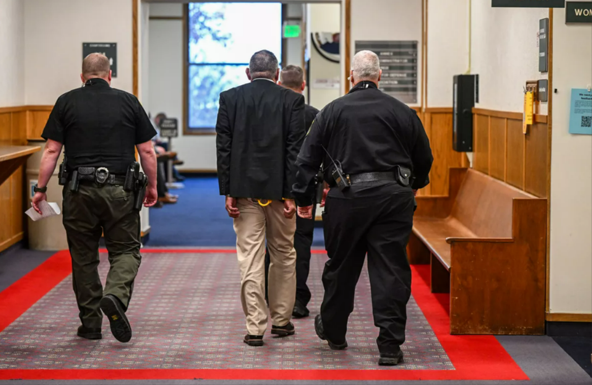 Richard Aguirre, center, is led down the hallway after being convicted in December 2023 for the 1986 killing of Ruby Doss in Spokane.