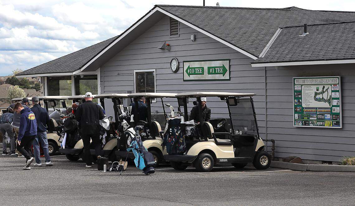 Golfer line up outside the clubhouse and pro shop preparing to start a round of golf at the 18-hole Canyon Lakes Golf Course in Kennewick.