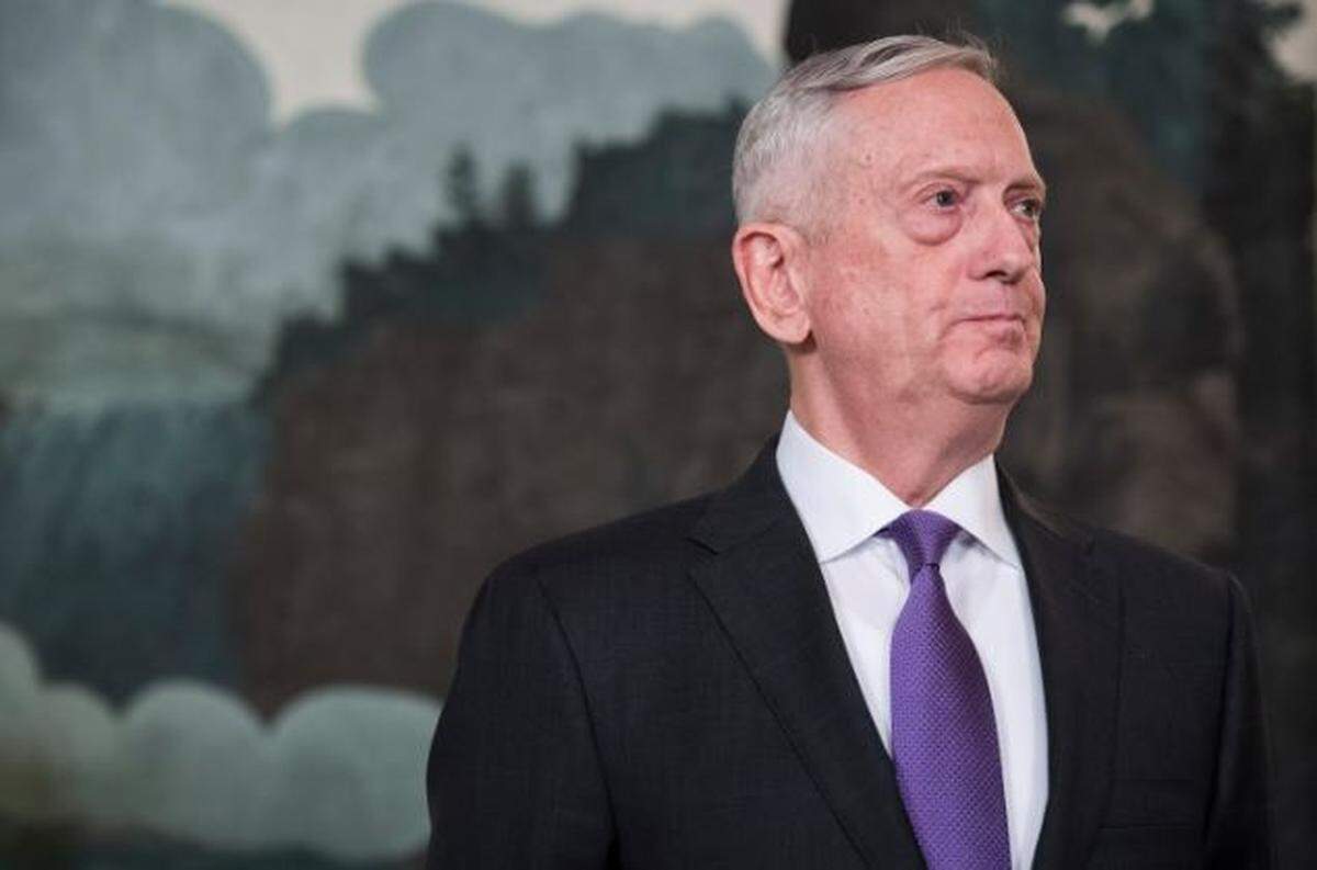 Defense Secretary Jim Mattis listens in March 2018 as President Donald Trump speaks at the White House.