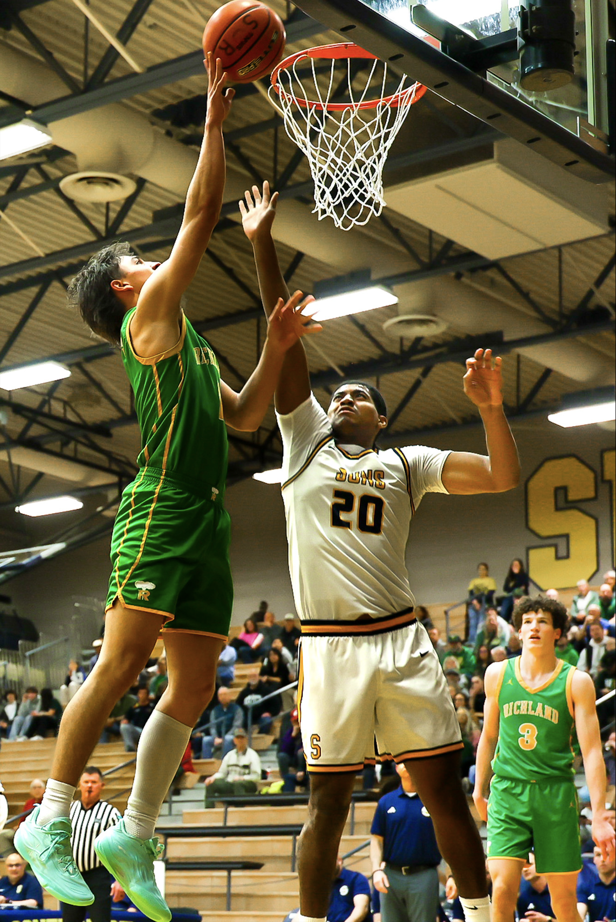 Richland’s Landen Northrop puts up a shot against Southridge’s Demario Cruz during the Bombers’ 109-53 win Friday night at Southridge High School in Kennewick.