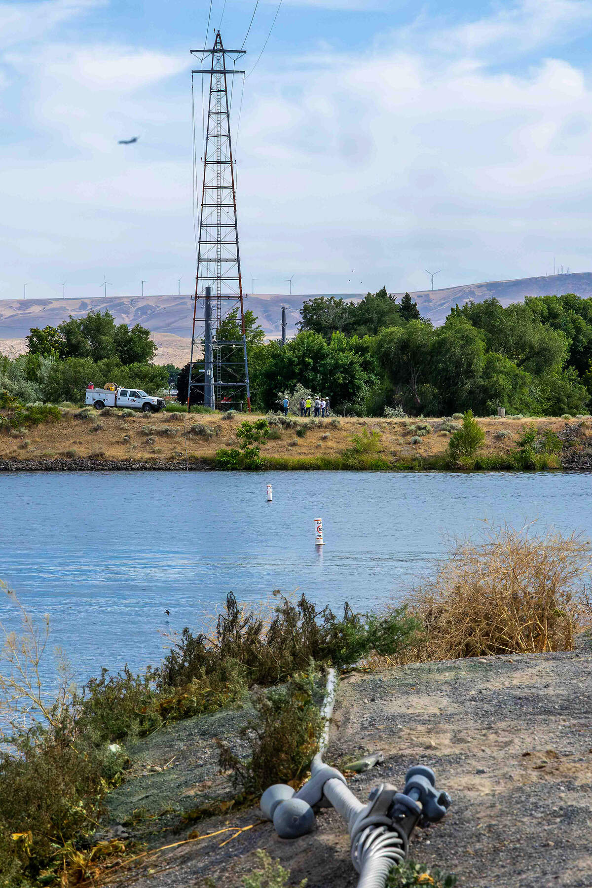 Crews work to repair a downed power line near Clover Island in Kennewick after a floatplane clipped the wire and crashed into the Columbia River killing two men on aboard.