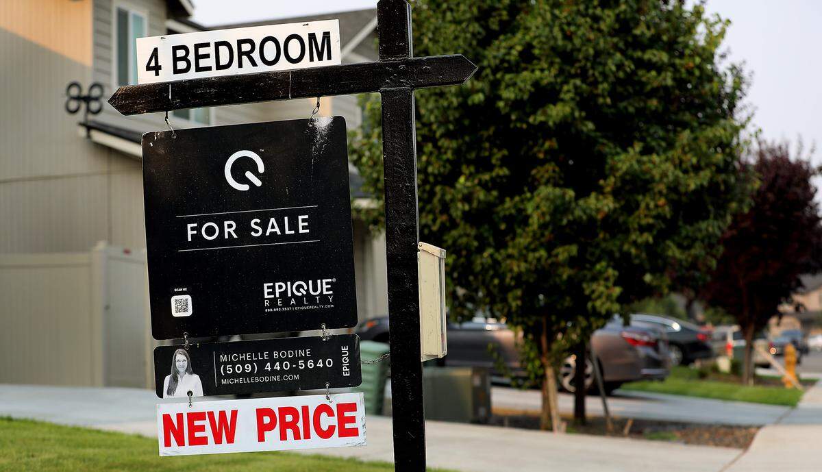 The yard sign for this four-bedroom house for sale in a south central Kennewick neighborhood advertises a new price.
