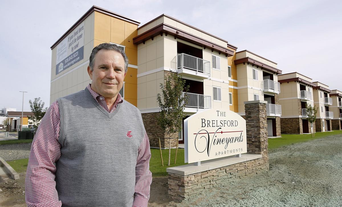 Developer Duane Brelsford stands outside the recently completed apartment building he constructed adjacent to the Washington State University Tri-Cities campus in Richland. The first phase of the complex has 81 units and features an outdoor pool, sports courts, and an indoor recreation area. An open house celebration is scheduled for October 10. Watch a video at: tricityherald.com/video