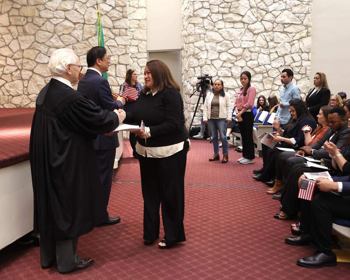 Candy Silva-Rauda receives a certificate of citizenship from Senior Judge Edward Shea at the U.S. District Court in Richland.