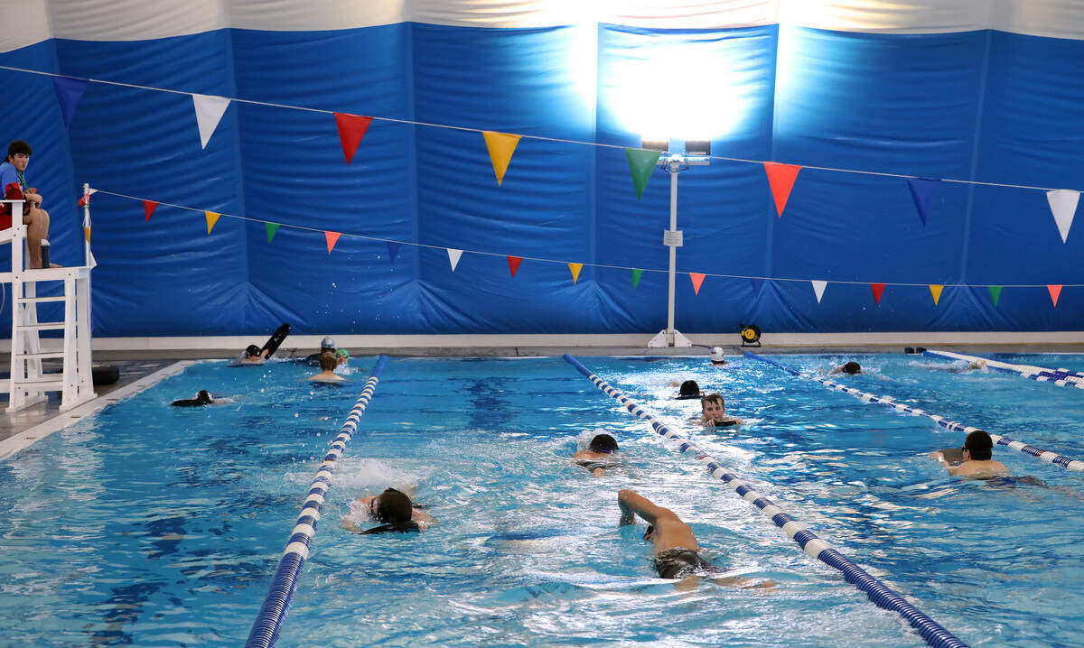 Members of the Pasco School District boys swim team practice recently inside the nearly $2 million bubble dome over the Olympic-sized pool at Pasco's Memorial Pool.  The dome towers at 38-feet high, 113-feet wide and 200-feet long is supported by air pressure.