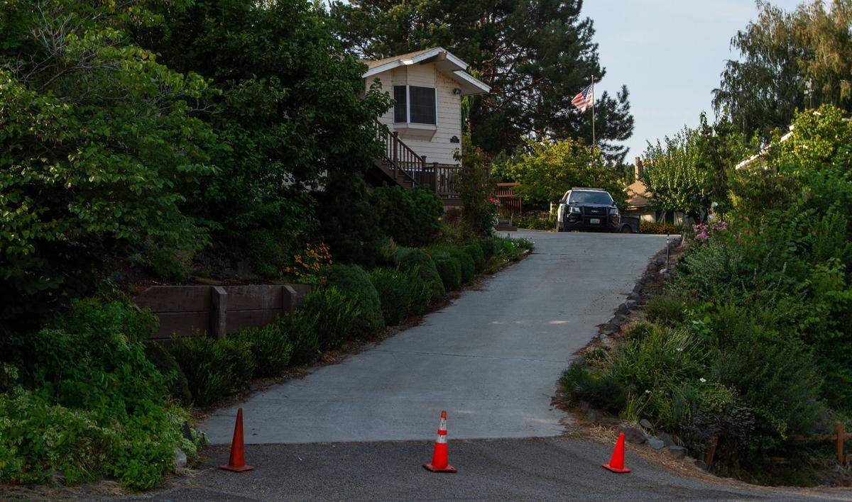 Police guard an active crime scene at a home in the 4300 block of South Gum Street in Kennewick. Two bodies were found in the house that also sustained some fire damage. The scene is being linked to a series of Tri-Cities shootings and fires that left four dead, including a gunman who died in a shootout with police in West Richland on Wednesday.