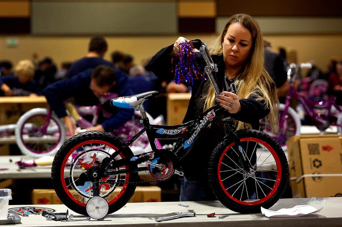 Local 598 union member Melissa Cannon joins more than 600 volunteers at the 13th annual Bikes for Tikes bike build event at the Three Rivers Convention Center in Kennewick. Volunteers assembled 1,600 bicycles in about four hours that will be distributed to children in need throughout the Mid-Columbia region during the holiday season. The organization was founded in 2009 by the Plumbers & Steamfitters UA Local 598 and through this year have donated more than 18,500 bicycles. A safety helmet is also included with each bike.
