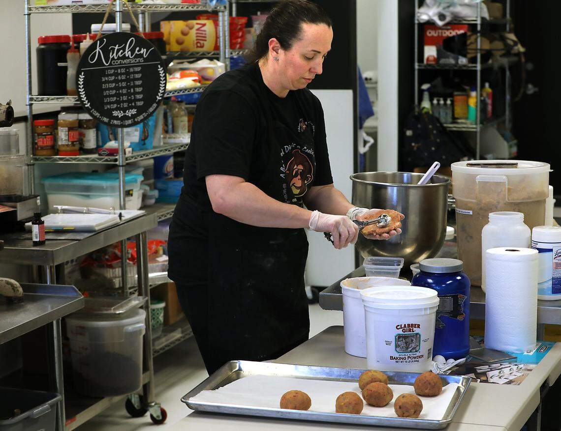 Kassie Norris makes her Grumpy Monkey cookies at her new site at Hansen Park in Kennewick.