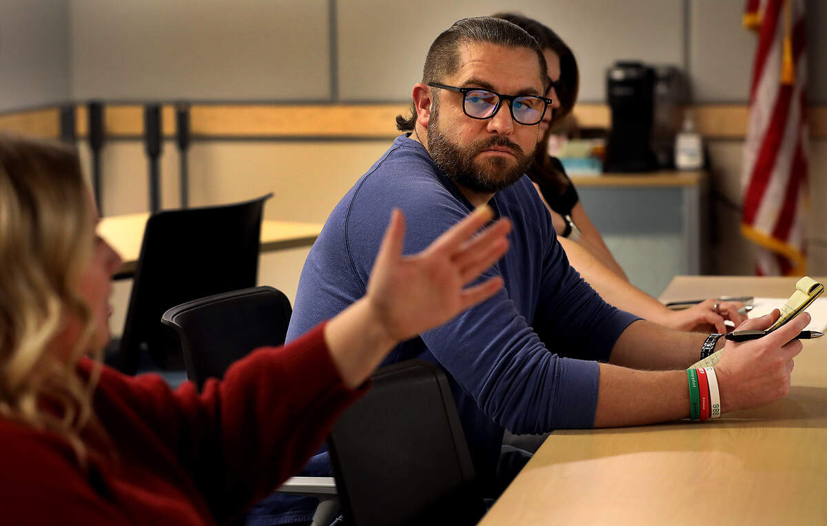 Cameron Fordmeir of Greater Columbia Behavorial Health listens to Nicole Marshall, Tri-Cities Chaplaincy bereavement supervisor, a November community partners meeting at the ESD 123 building in Pasco.