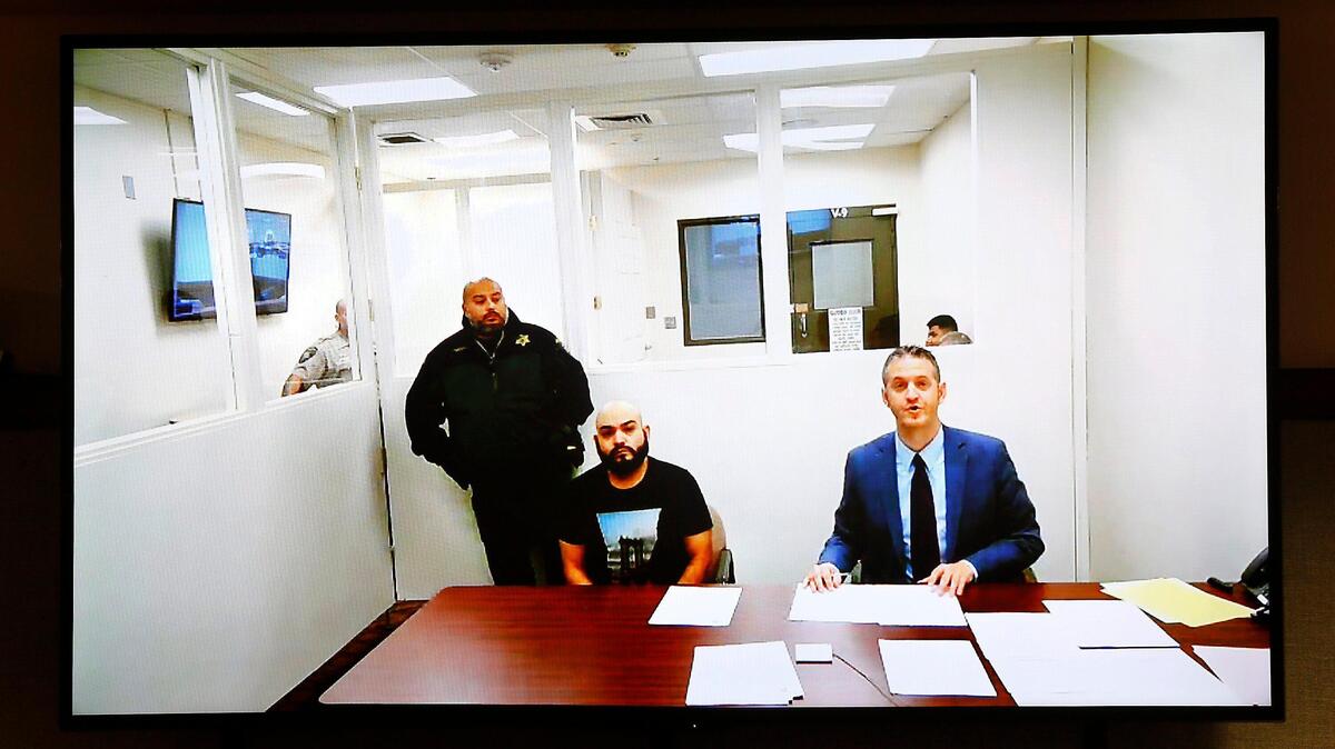 Murder suspect Clemente Rodriguez Torres, seated left, makes his first appearance in Franklin County Superior Court via video link Wednesday with provisional defense attorney Michael Quillen. The 33-year-old Prosser man recently turned himself in at the United States-Mexico border for allegedly killing his mother earlier this year. Watch a video at: tricityherald.com/video
