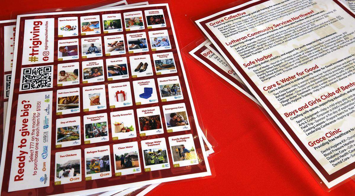 Laminated menus of choices and information sheets provide details about the charities benefiting from the Giving Machines stationed in the lobby of the Fairchild Cinemas Queensgate in Richland.