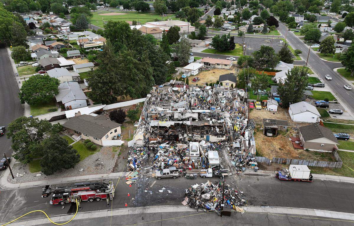 Richland firefighters remain on the scene Friday morning at the site of Thruday's two-alarm fire at the "junkyard" house at 2100 Pullen St. in Richland.