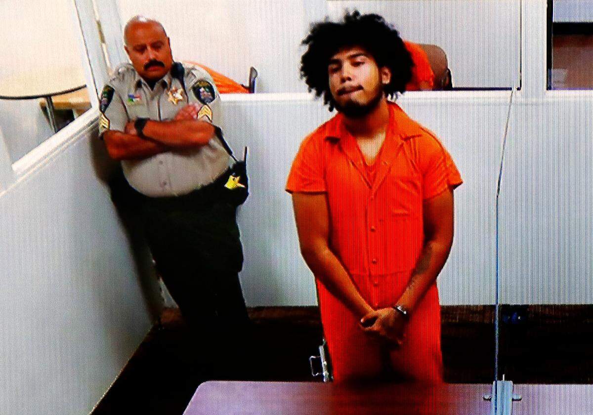 Murder suspect Osman Morales Salto stands during his preliminary hearing using a video link from jail in Franklin County Superior Court in Pasco.