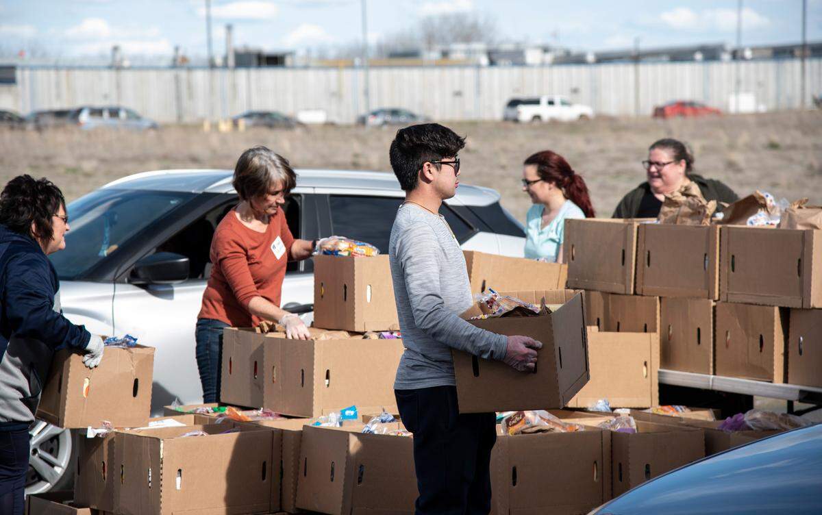 Volunteers packed then distributed boxes during Second Harvest’s drive-thru food distribution at their hunger solution center in Pasco on March 24. Another drive-thru is planned for 3:30 p.m. on March 26.