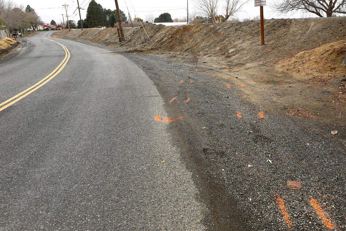 Law enforcement investigation paint marks outline the path of the four-wheel drive UTV on the shoulder of Bryson Brown Road and up the dirt embankment where Nadine Locati was killed early Sunday morning when the four-wheel drive UTV she was riding in overturned in Finley. The driver, David P. Miller, 30, is facing vehicular homicide charges.